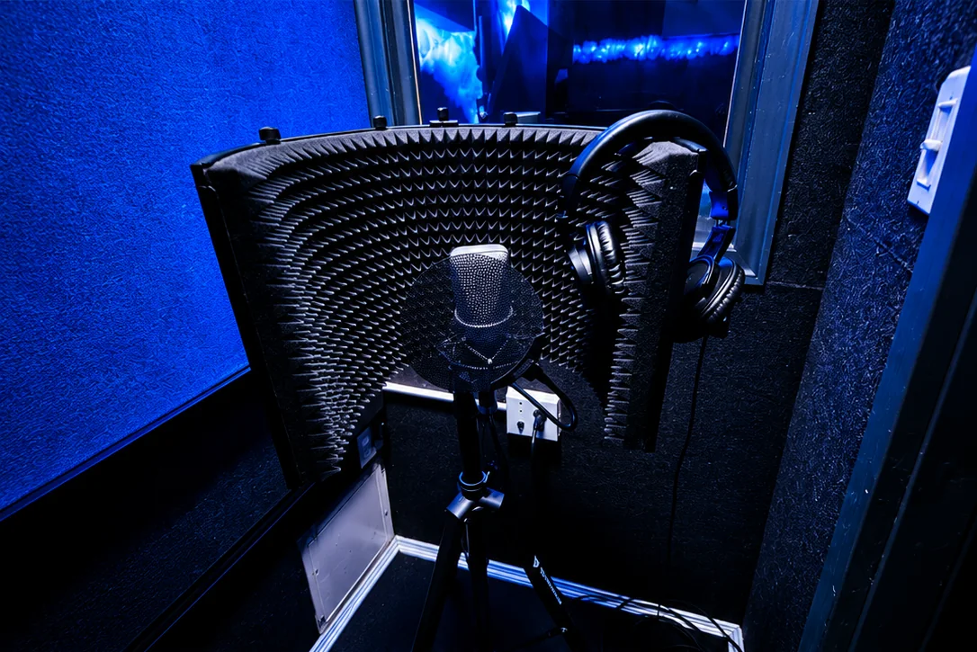 The Brooklyn vocal booth: mic behind a foam shield, headphones hung ready