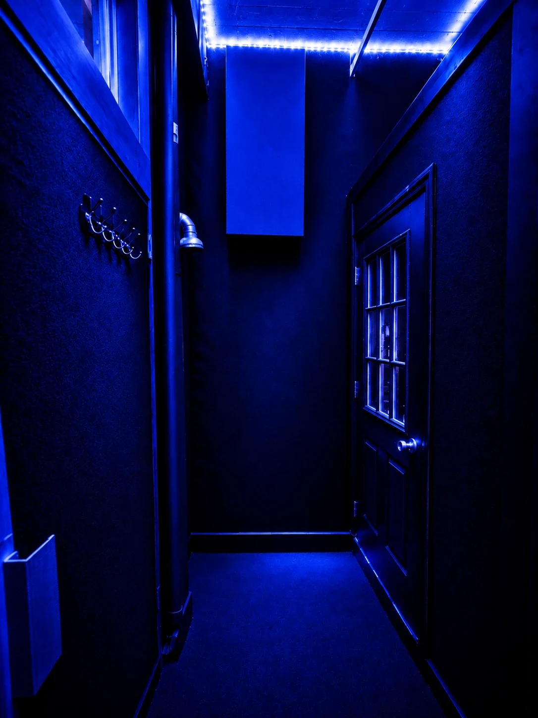 Blue-lit hallway into the Brooklyn studio